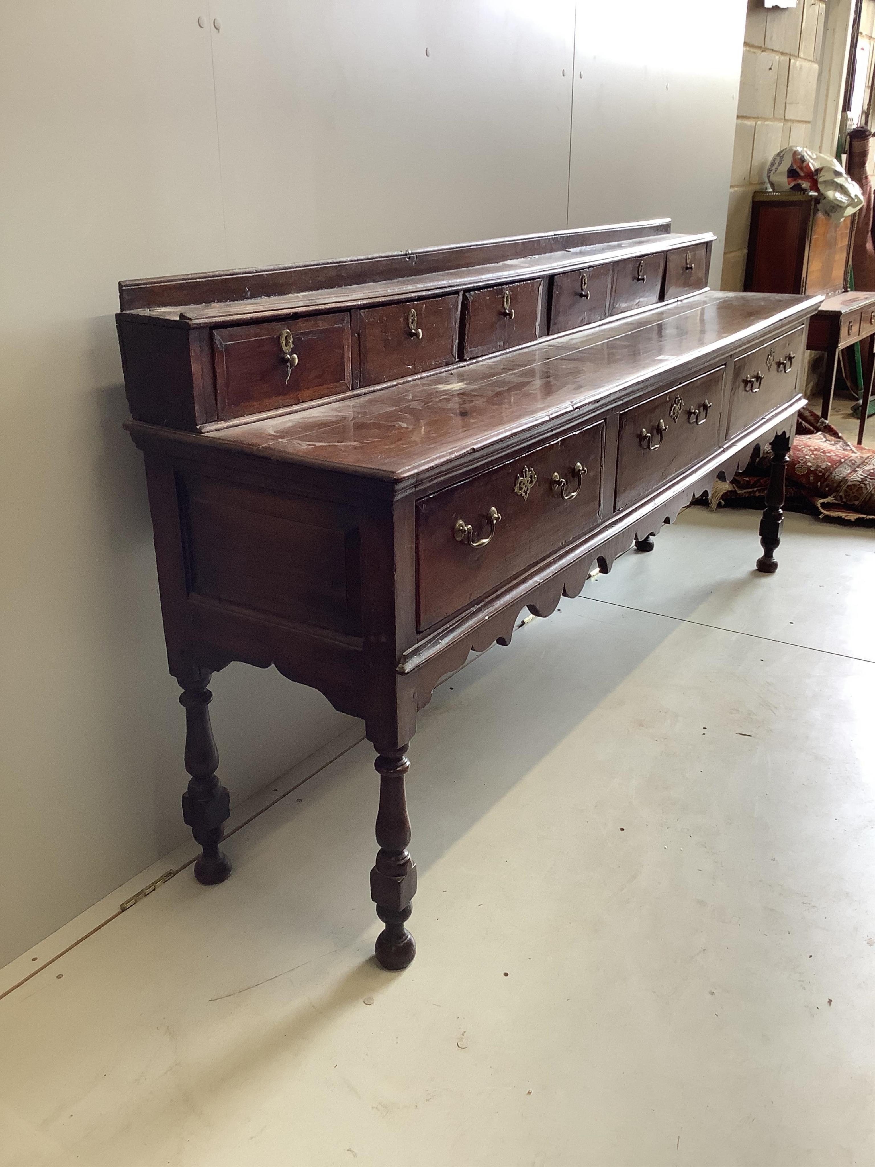 A mid 18th century oak low dresser, width 207cm, depth 46cm, height 97cm. Condition - fair
